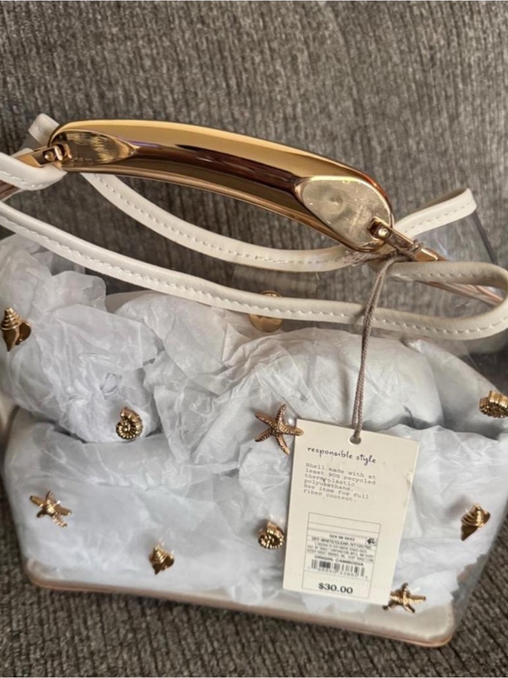 A new Day clear handbag with gold starfish and shell embellishments
